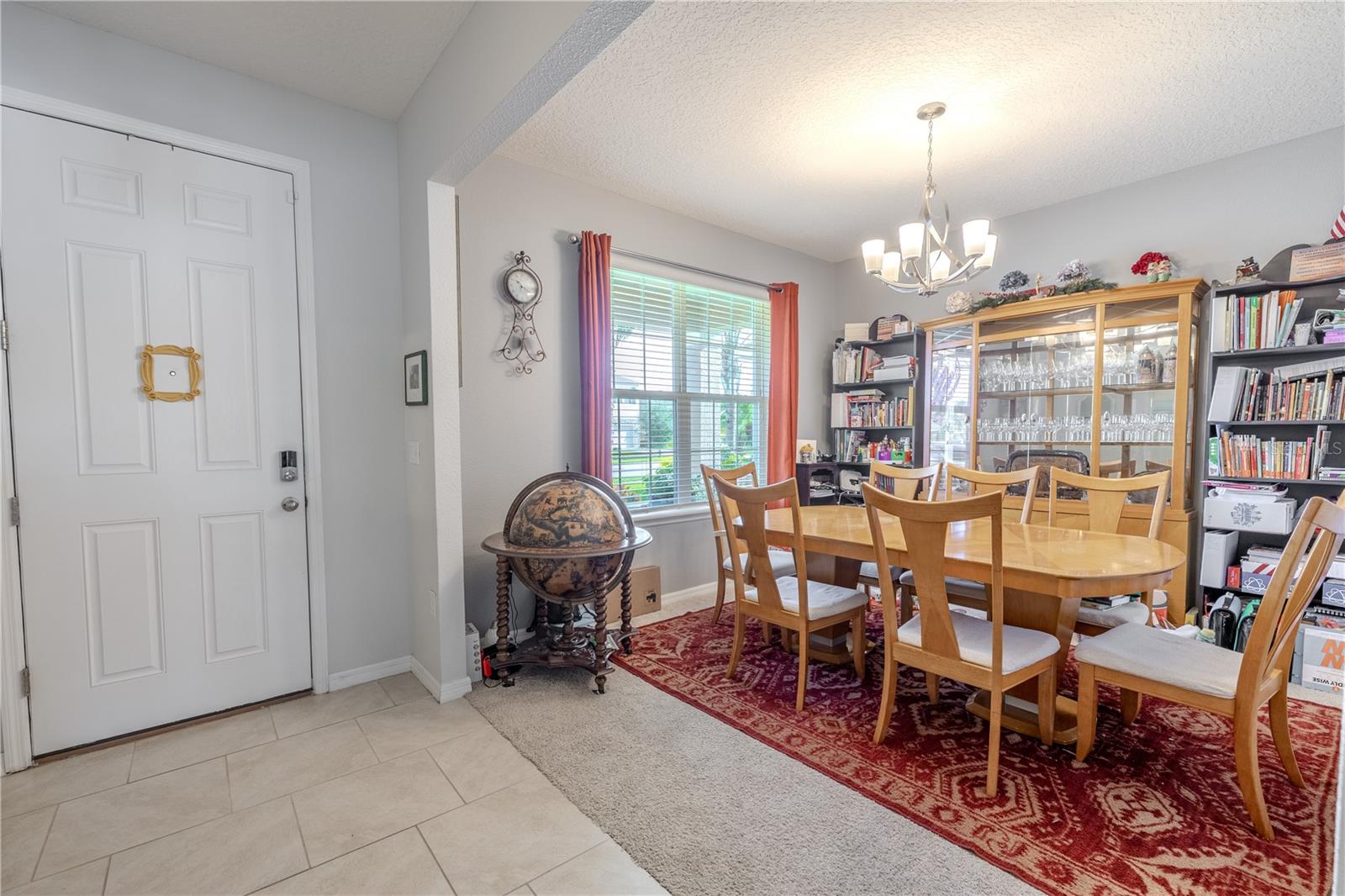 Bright front entry opens to the formal dining area, setting a warm tone as soon as you step inside.