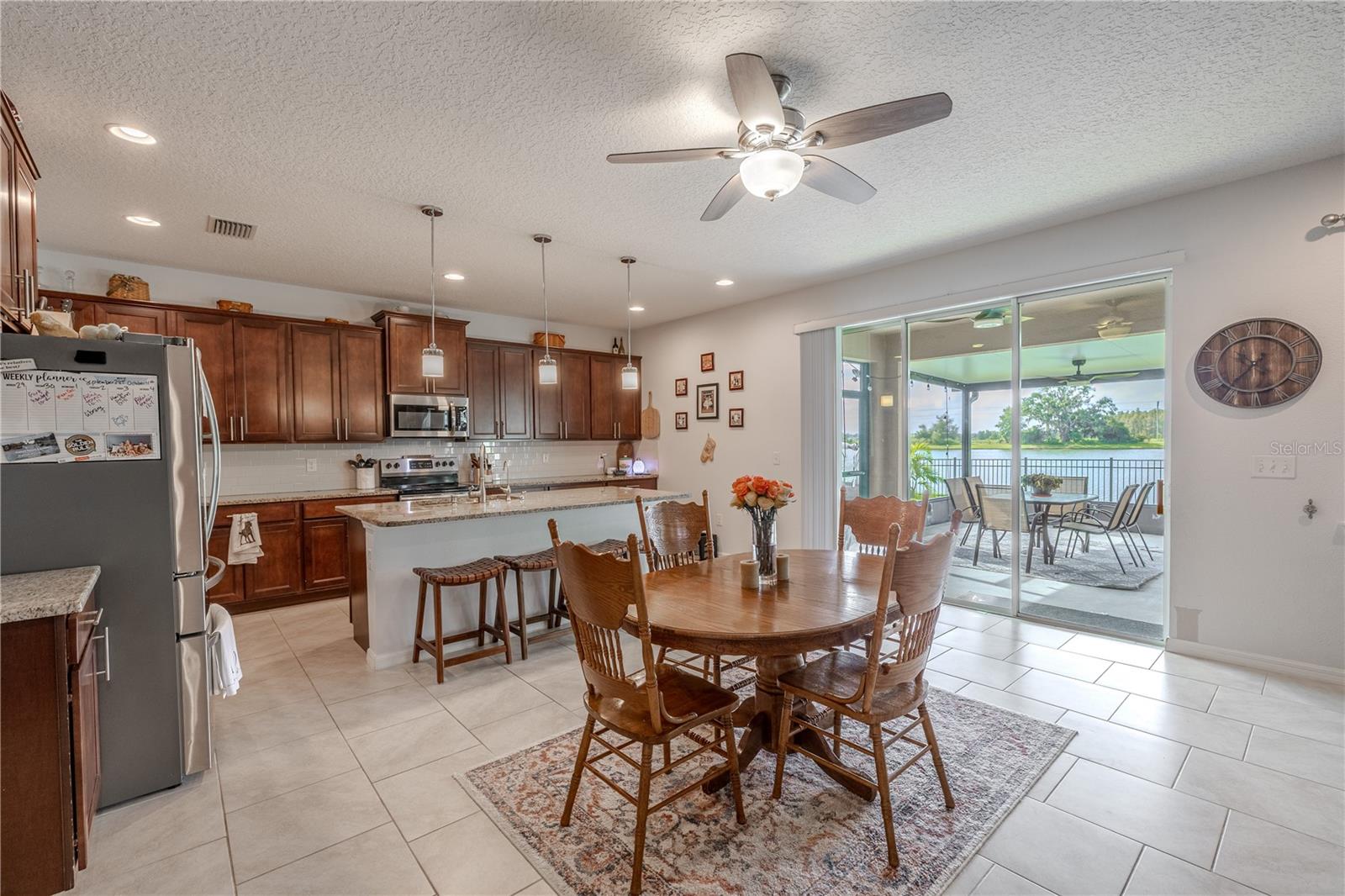 Cozy breakfast nook with natural light and peaceful water views through sliding glass doors to the patio.