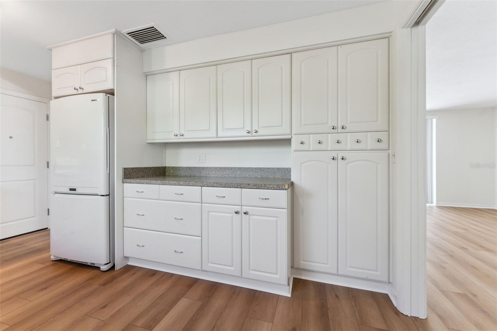 Storage galore! The kitchen boasts an abundance of cabinet space, keeping everything organized and within easy reach