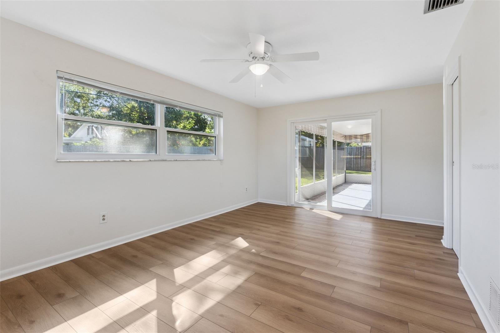 Enjoy seamless indoor-outdoor living! The primary bedroom features hurricane-impact sliders that open directly to the screened-in porch