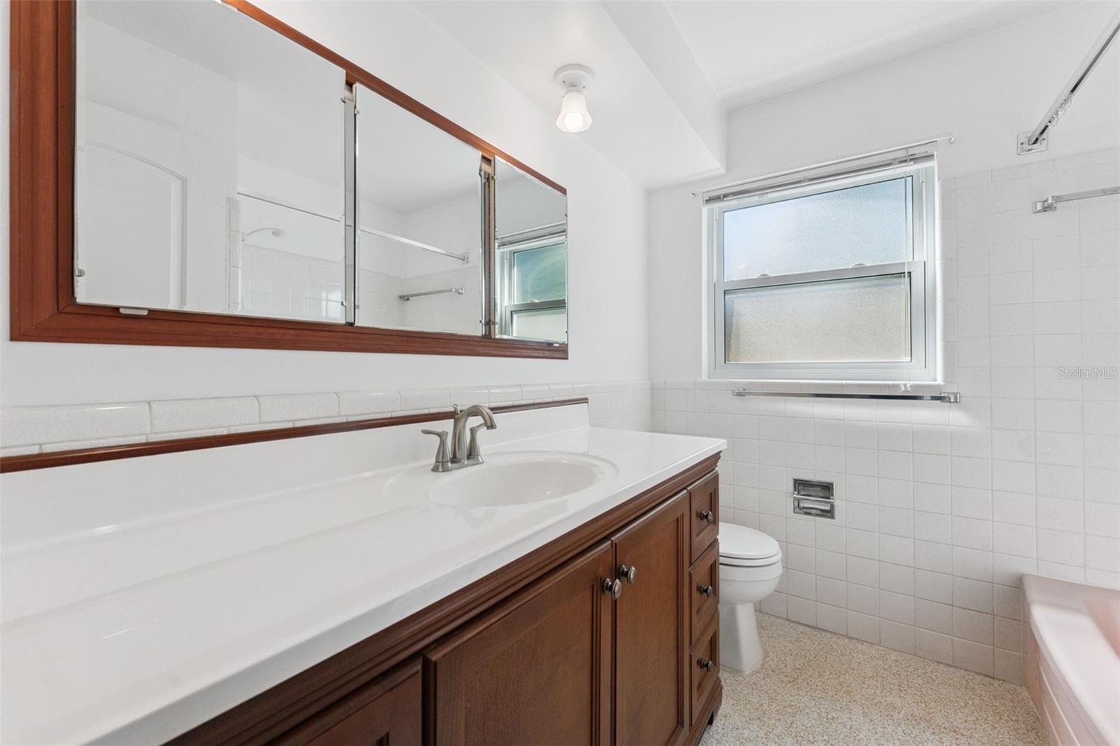Functional and stylish—the hall bathroom boasts a large vanity with plenty of space for your daily routine