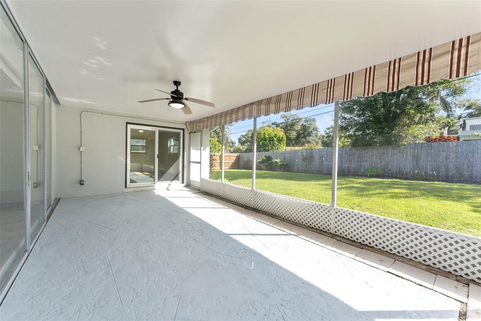 Enjoy peaceful views and fresh air from the screened-in back porch, perfectly overlooking the spacious backyard