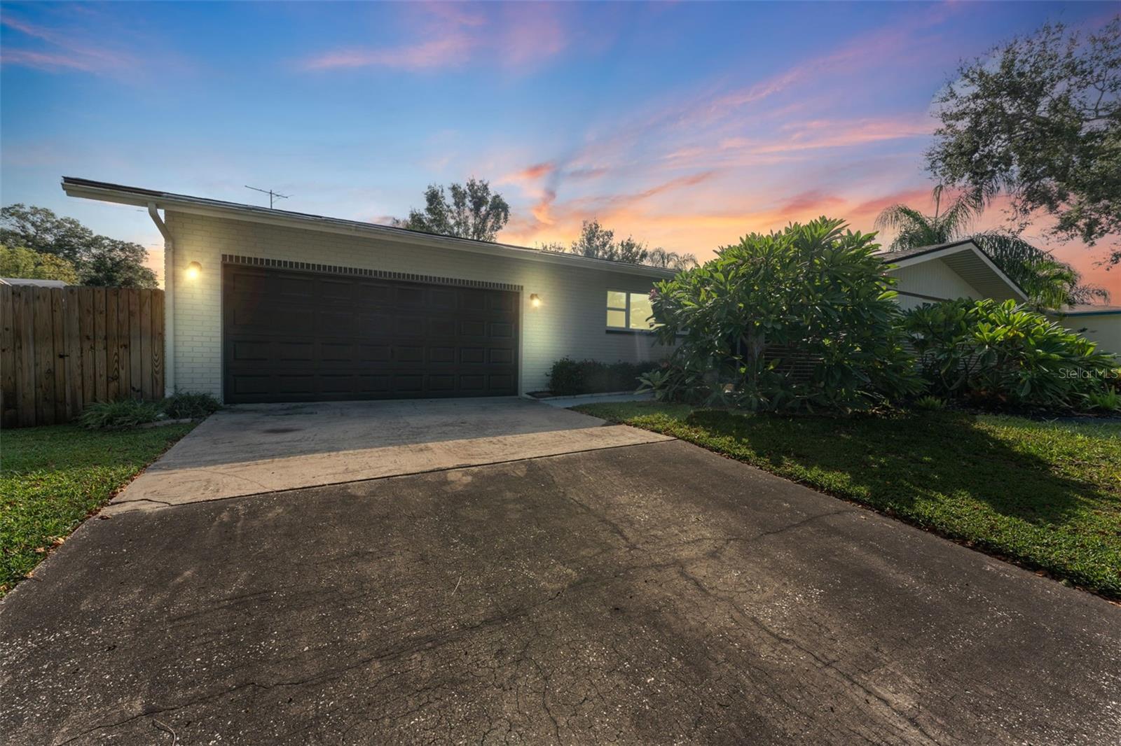 Stunning at every hour—the front of the home glows beautifully at dusk, showcasing its curb appeal and welcoming charm
