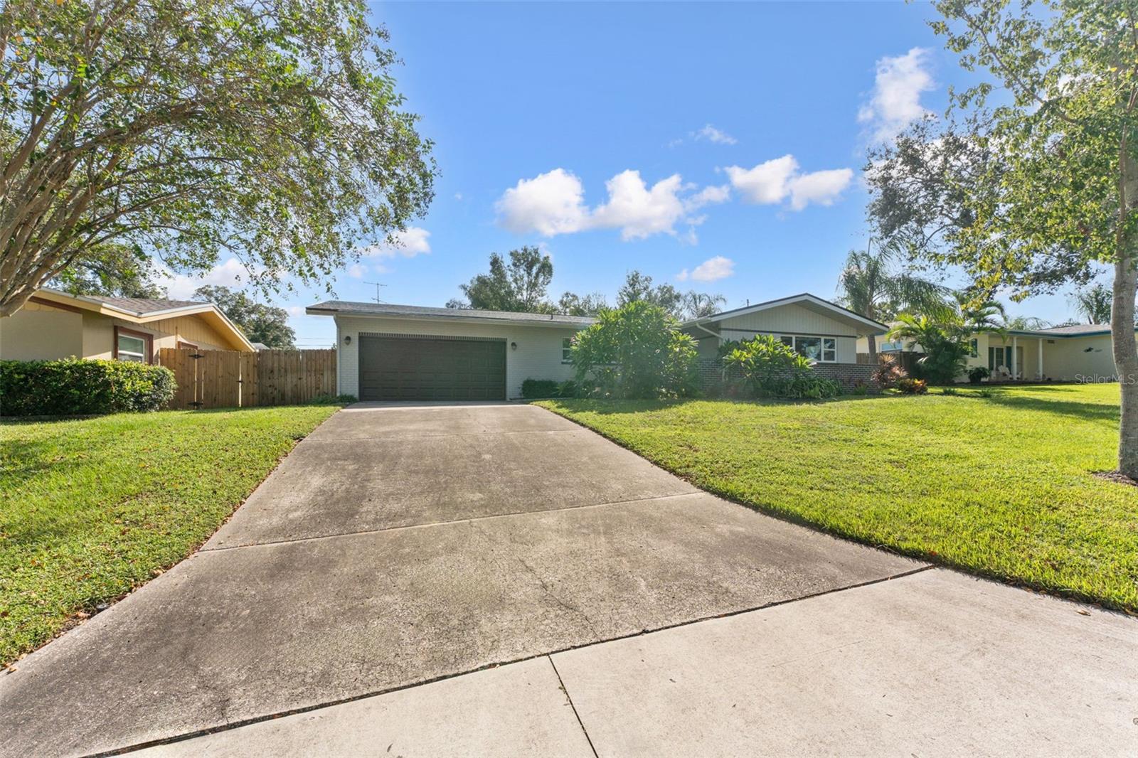 Spacious driveway and oversized two-car garage — perfect for parking, storage, and everyday convenience