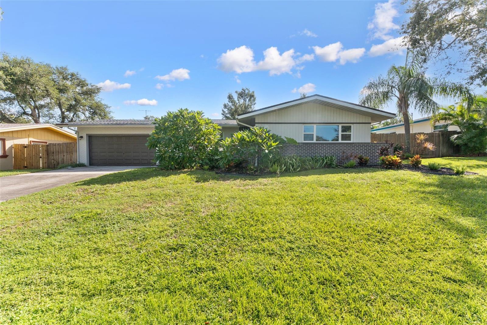 Excellent curb appeal with lush landscaping, classic charm, and timeless Florida character that instantly feels like home