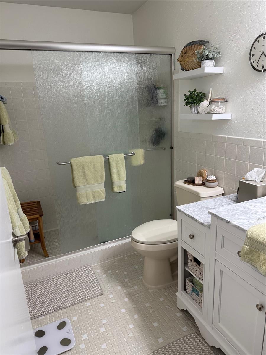 The totally updated primary ensuite bath offers a walk-in shower and gorgeous vanity.