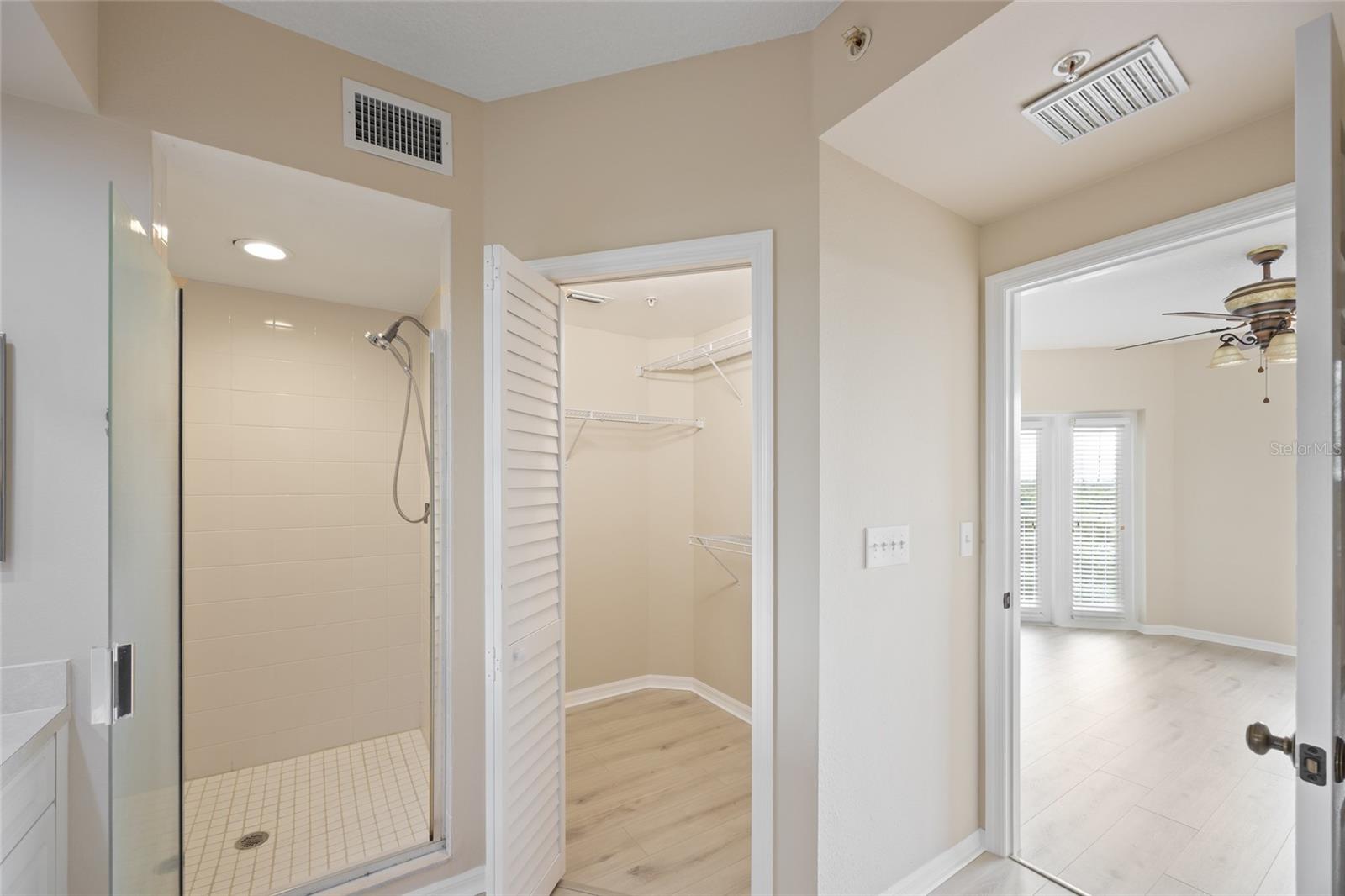 Luxurious Primary En Suite Bathroom with walk in his & hers closets.