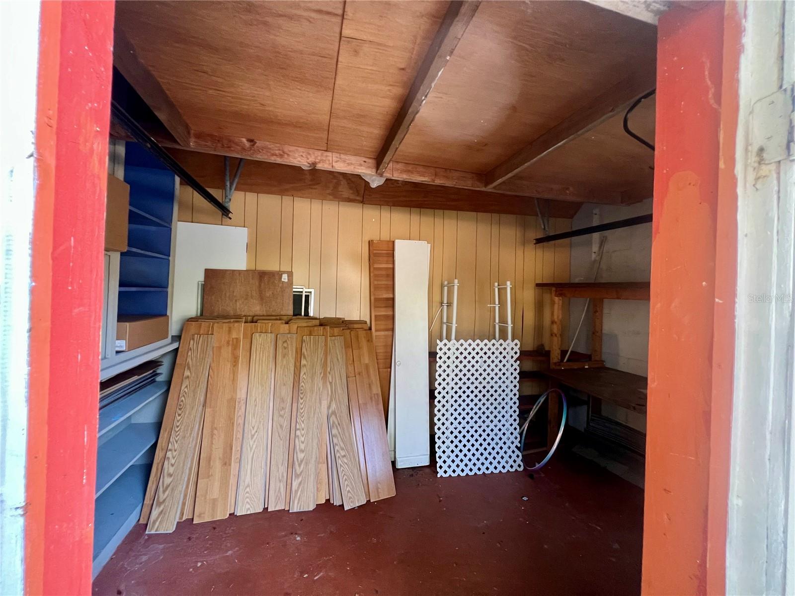 Front storage room with lots of wood flooring for the next owner to complete.