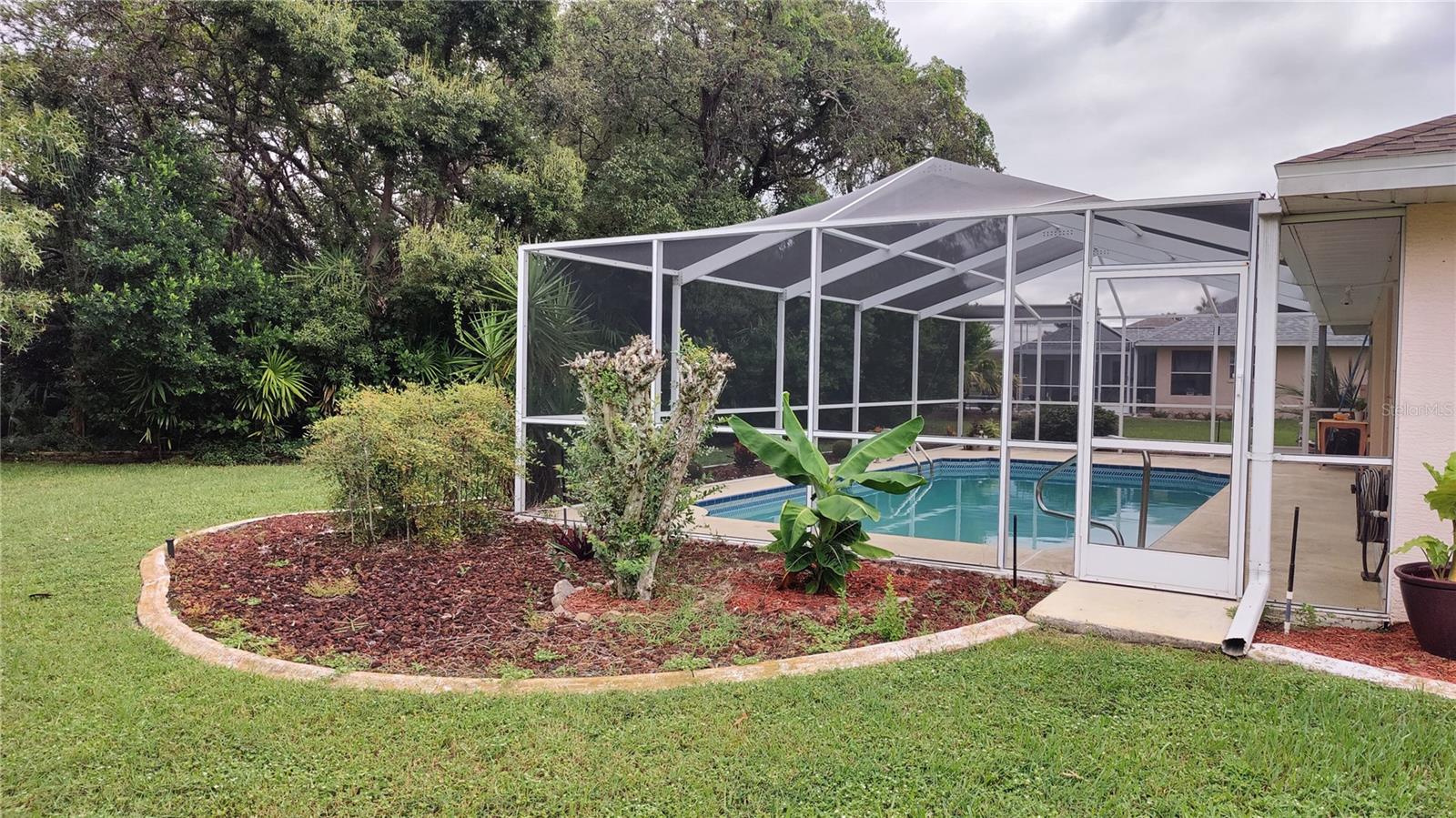 Lovely large pool features an outside shower, changing bathroom and covered lanai area.  Trees in back yard provide privacy and a nice shady view to enjoy the back yard pool area.