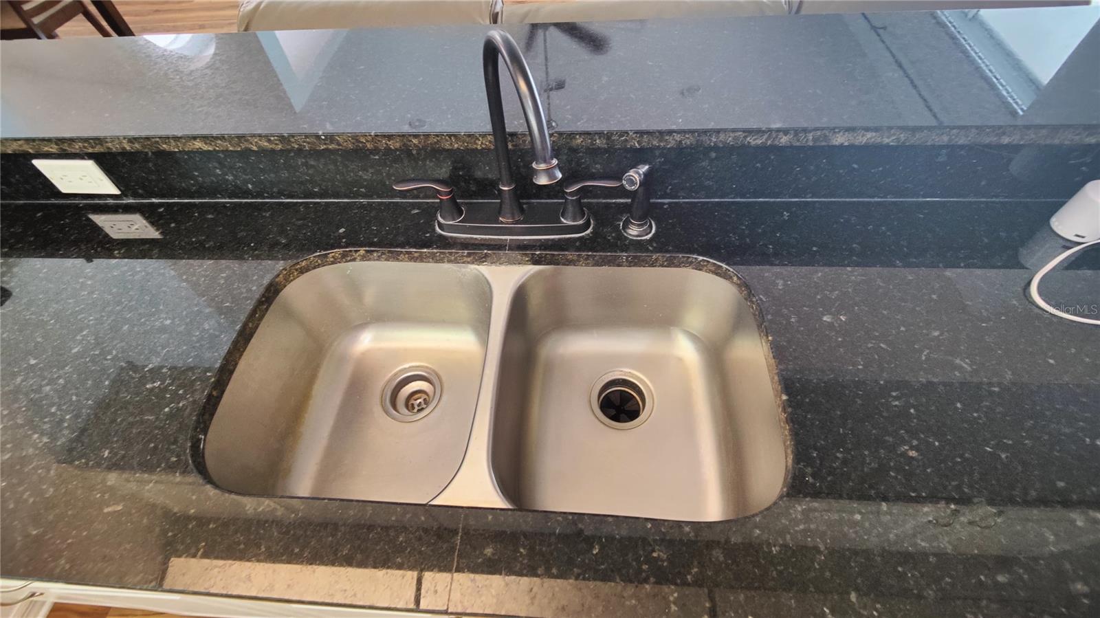 Deep stainless steel double sink, high arch faucet and sprayer makes cooking and cleanup a breeze.  This can also serve as a breakfast wet bar with stool seating in the great room.