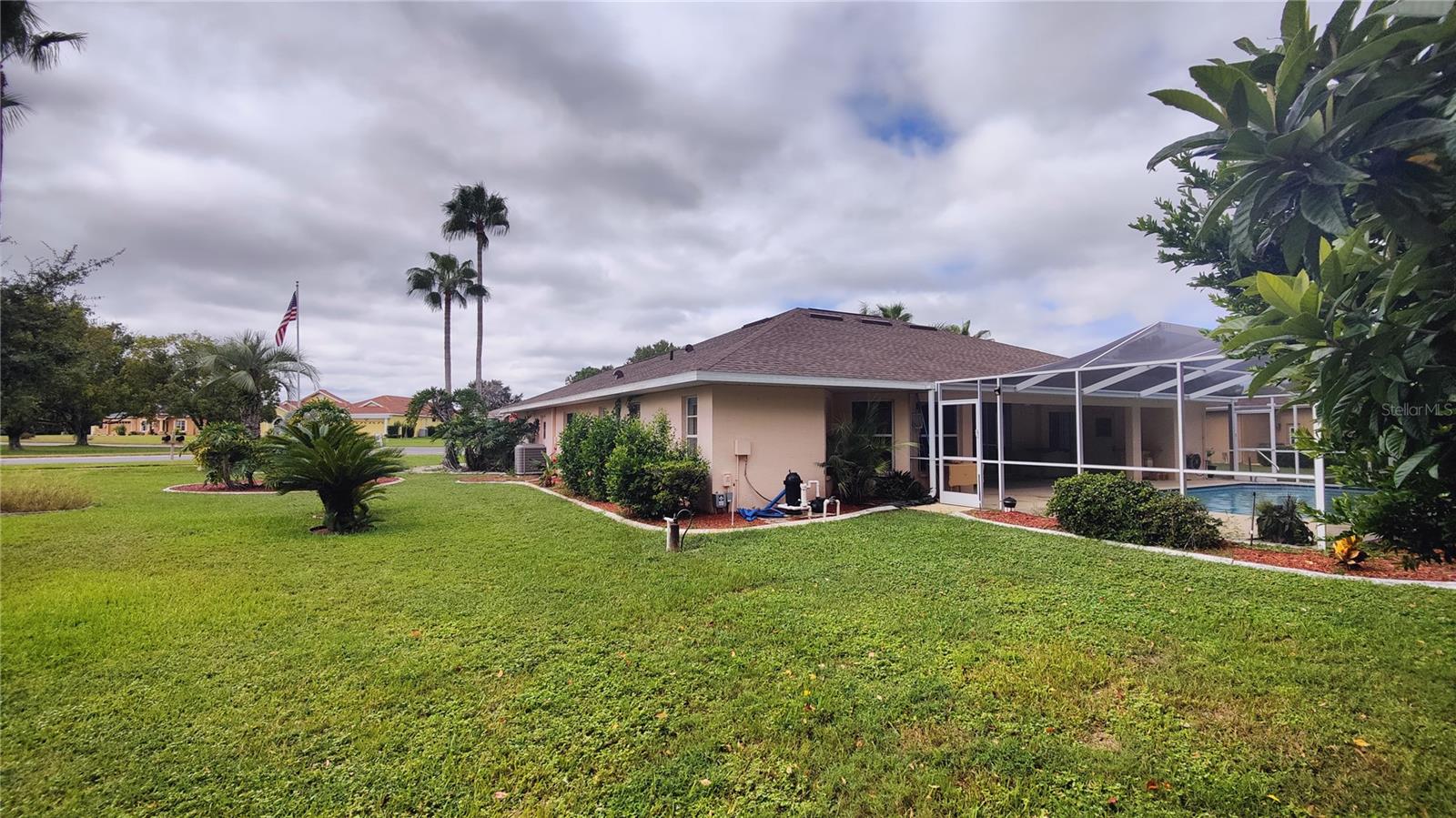 Right side of home shows all the elbow room and privacy you enjoy with this large, nearly 1/2 acre lot