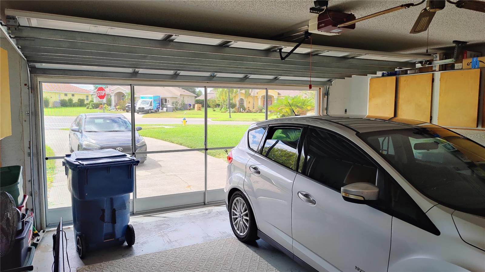 oversize 2 car garage is 21' X 20'.  Re-enforced hurricane rated garage door was installed in 2017.  Garage has a fan, garage door opener, storage cabinets and screen doors to save on cooling costs.