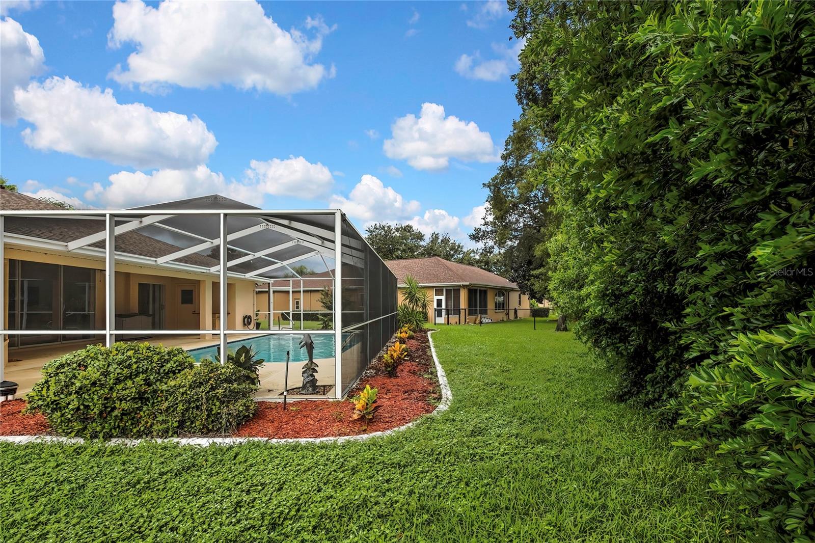 Lovely large pool features an outside shower, changing bathroom and covered lanai area.  Trees in back yard provide privacy and a nice shady view to enjoy the back yard pool area.