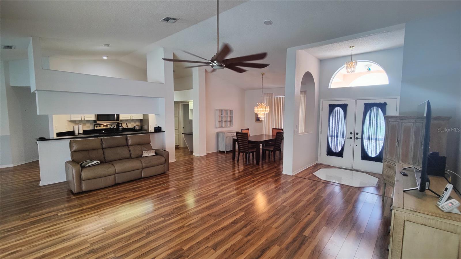 Living/dining/kitchen great room has lovely wood floors and a cool giant fan to keep you comfortable.  Furniture is negotiable.