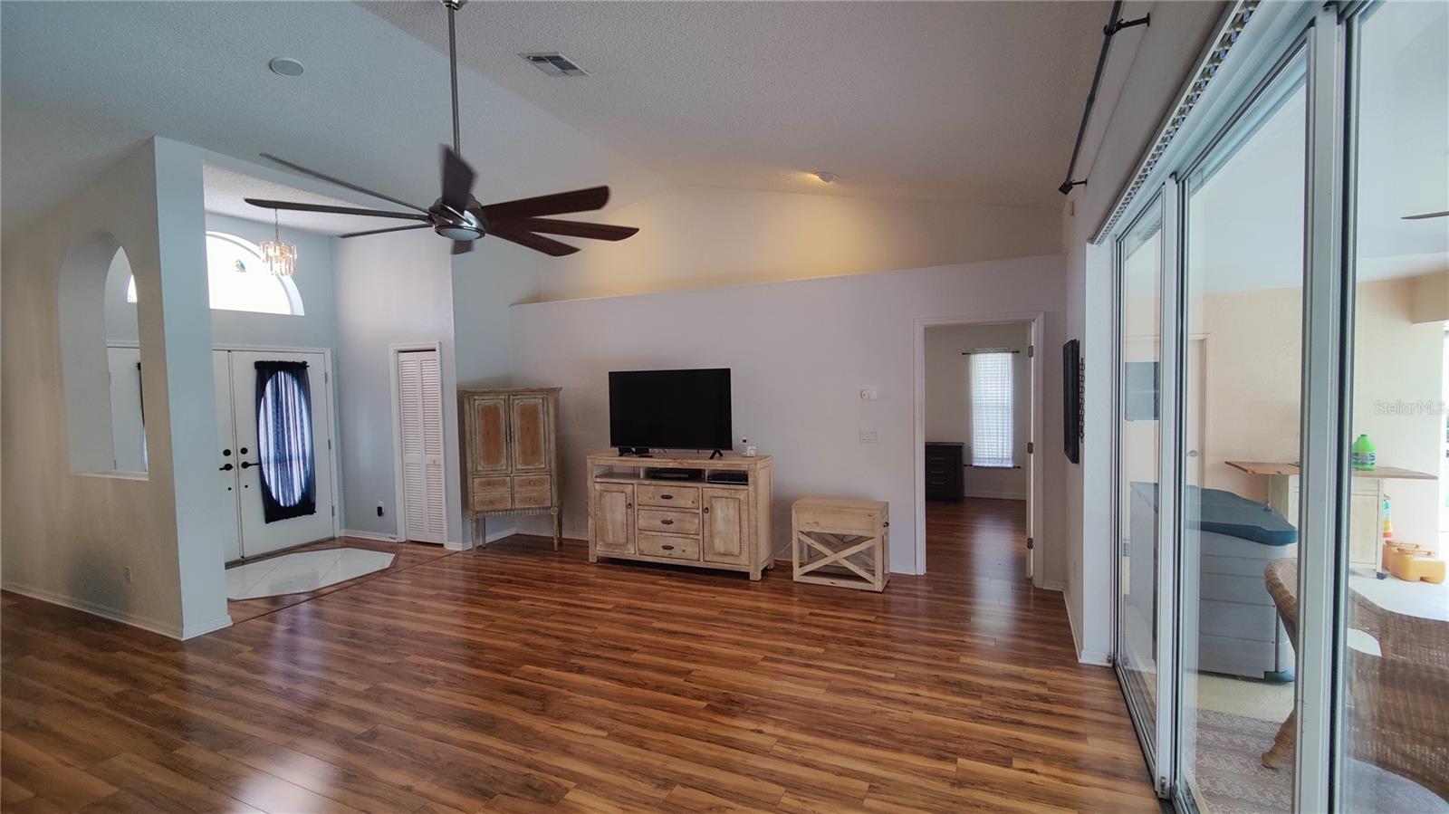 Great room looking at the primary bedroom which has gorgeous woof flooring which continues into bedrooms.  Split bedroom plan for your privacy and comfort.