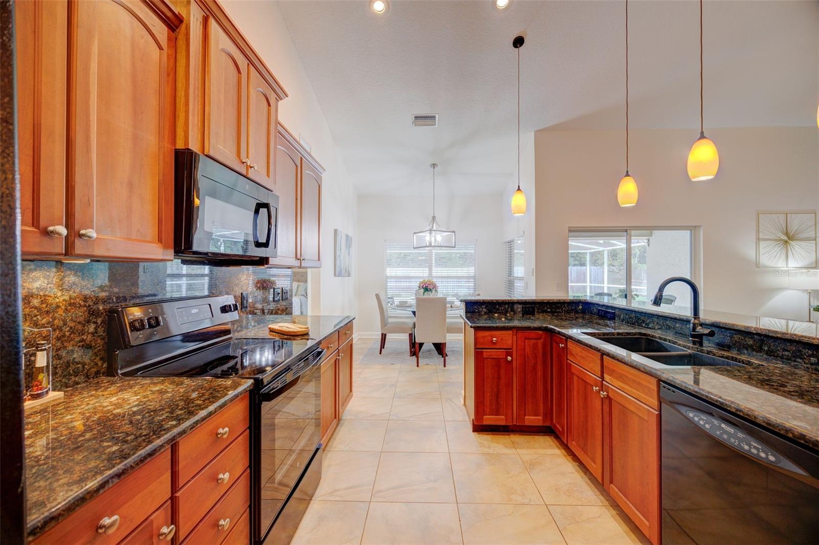 Sleek appliances match the granite counters & backsplash