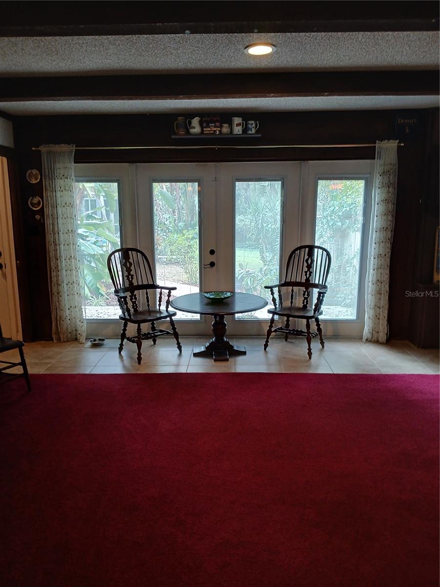 Game room  Hurricane rated French doors looking out towards rear deck to pool
