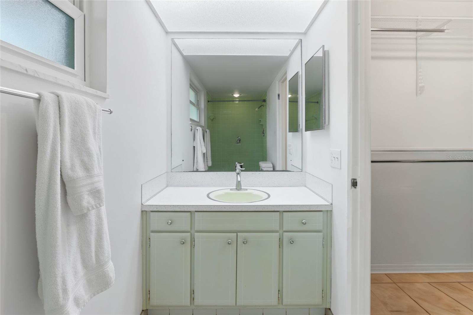The original vanity offers plenty of counter space and storage
