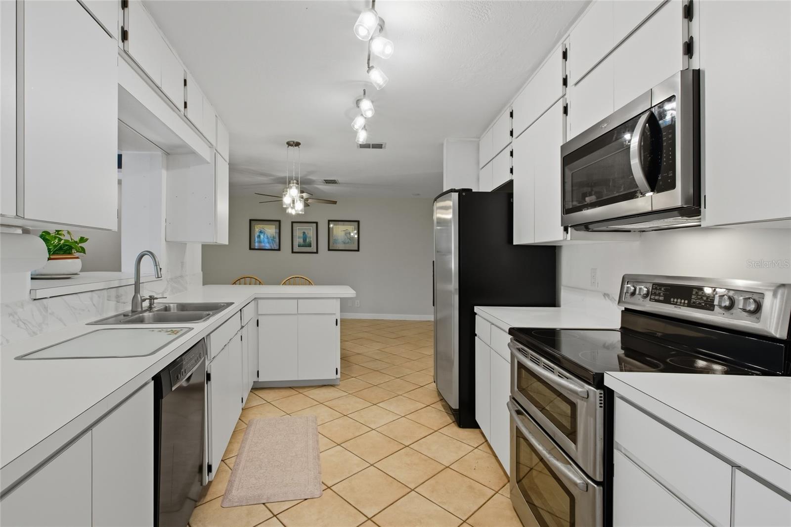 The galley-style kitchen offers deep cabinets as well as uppers for plenty of storage!