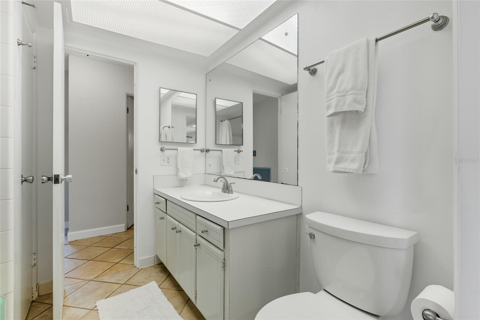 This full bath with tub services 2 guest rooms and has a pass-through to the family room for great efficiency