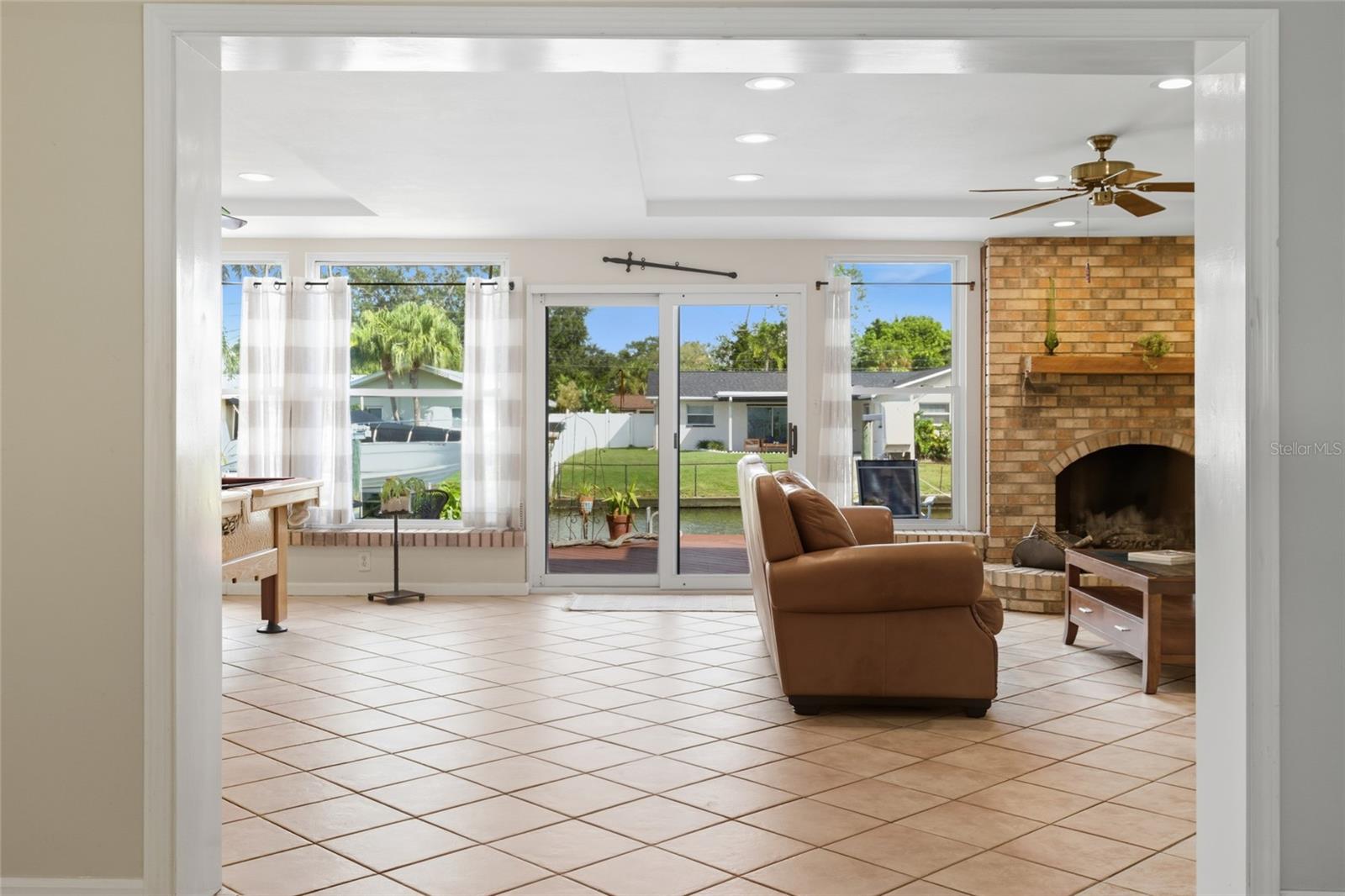 A massive family room with a wood-burning fireplace anchors the back of the home!