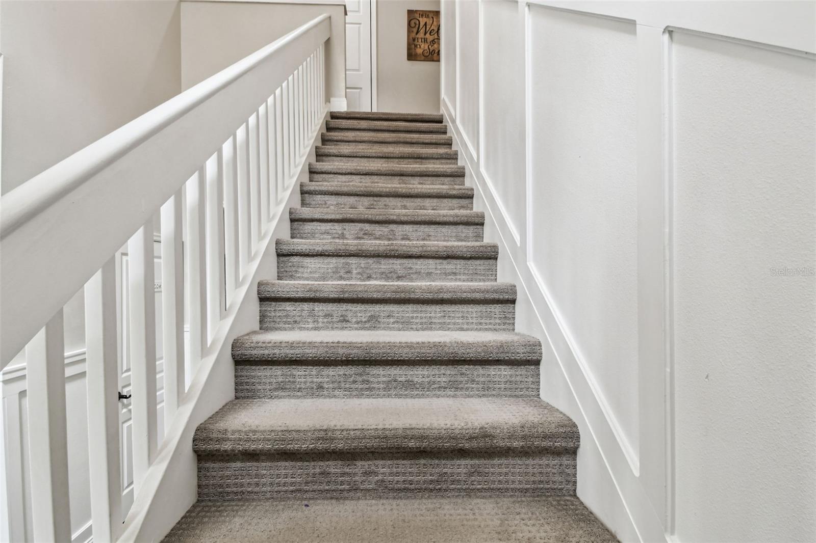 Stairs to the four bedrooms, two bathrooms and laundry