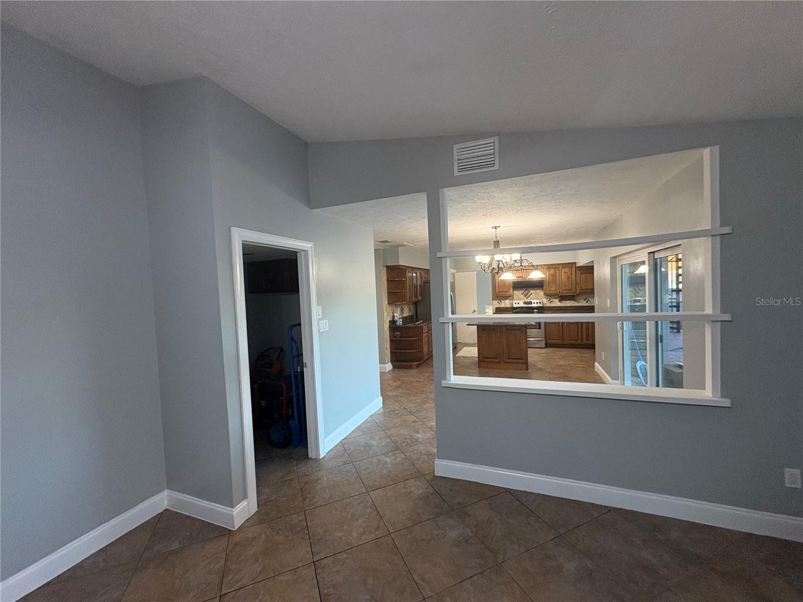 Entertainment room with entrance to laundry room and garage