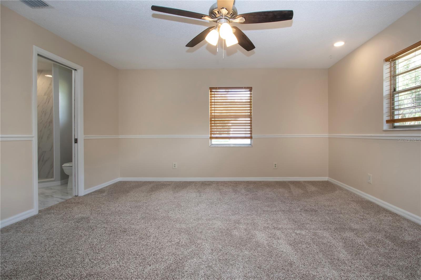 Owners bedroom with pocket door to the bathroom