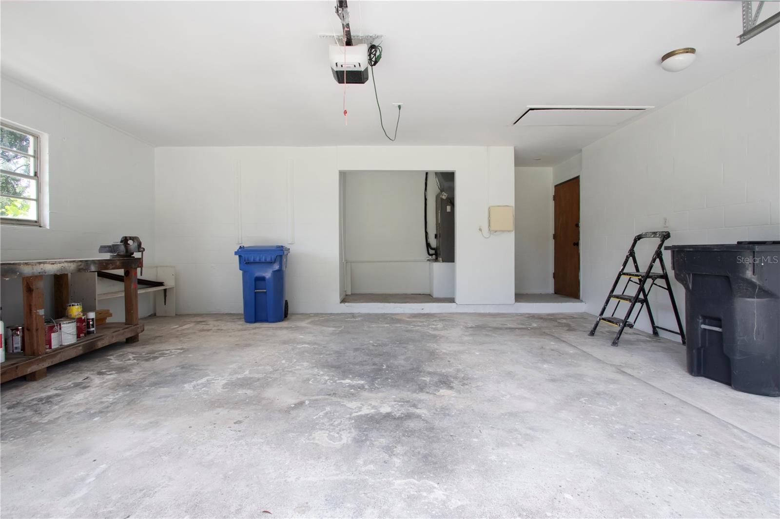 Freshly painted garage with new garage door and work bench