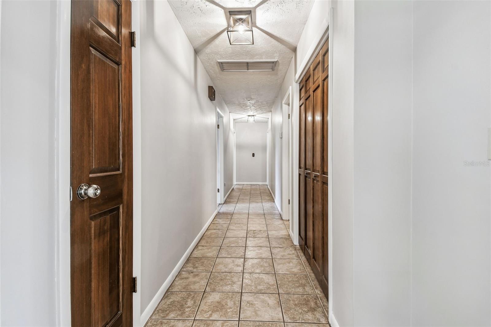 Hallway to the guest bedrooms and primary ensuite.