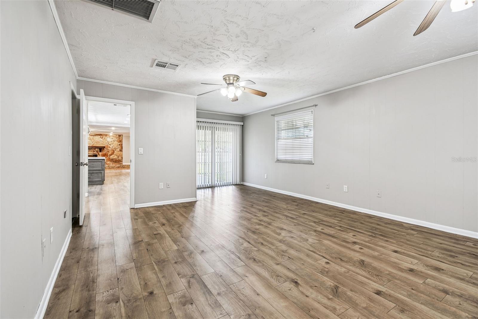 Secondary Ensuite looking out to the kitchen and family room. Sliding doors to rear patio from Ensuite
