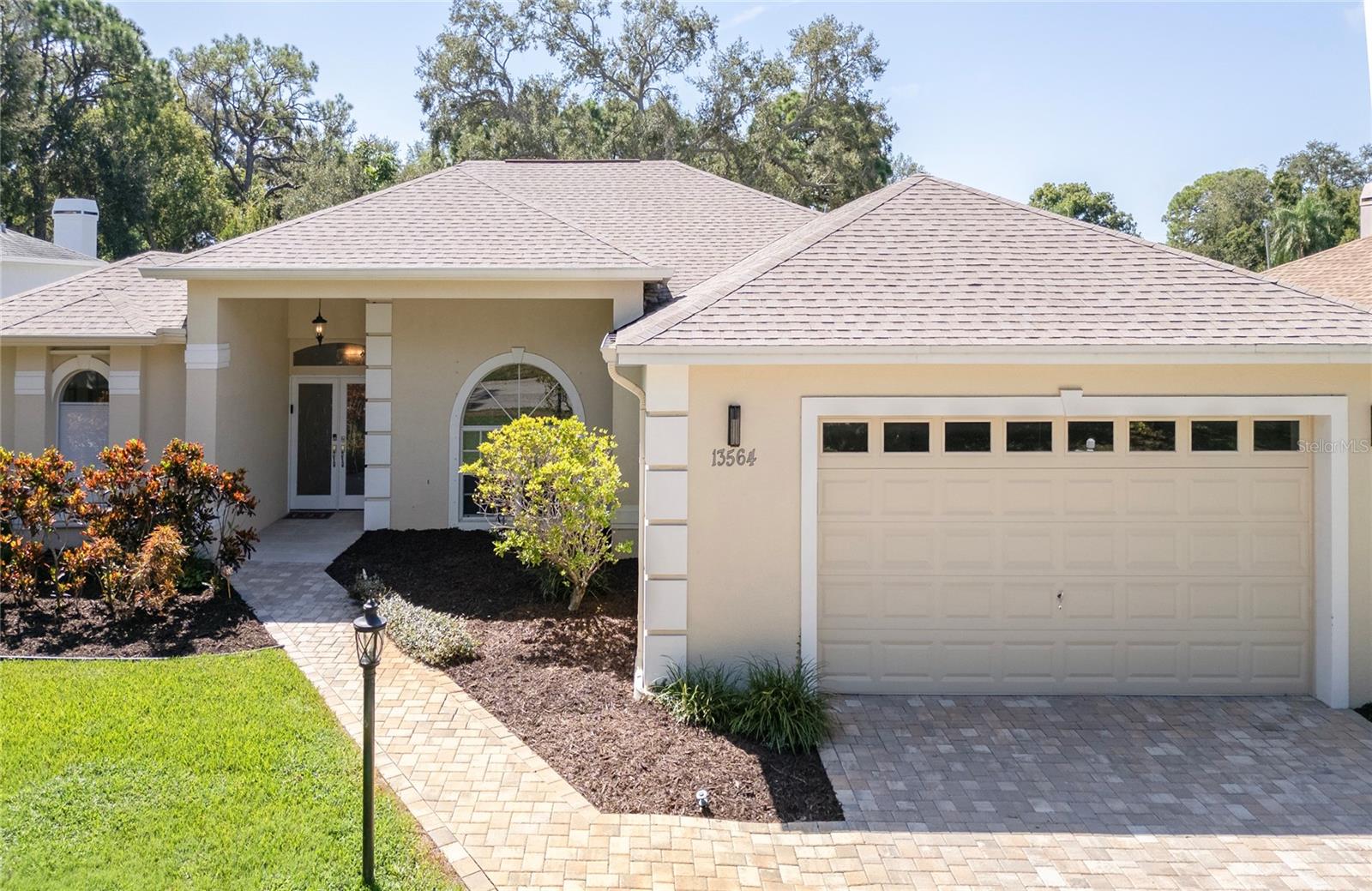Elegant home with pavers and time-saving irrigation system