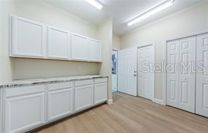 Laundry room with pantry and storage
