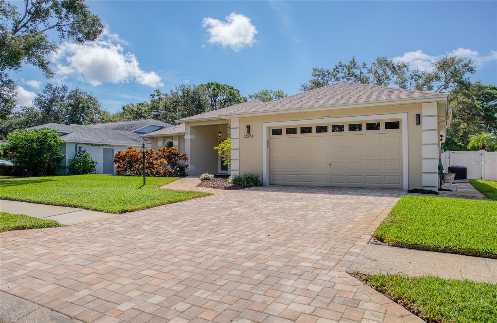 Pavered driveway to oversized garage