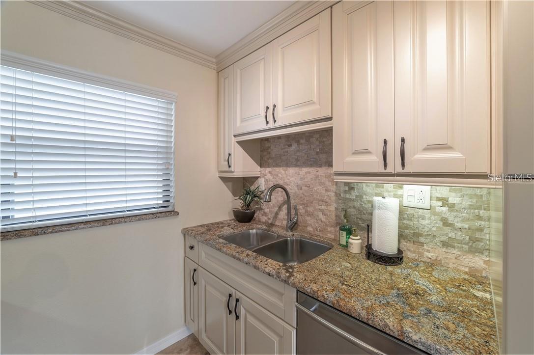 Kitchen with stainless steel dishwasher.