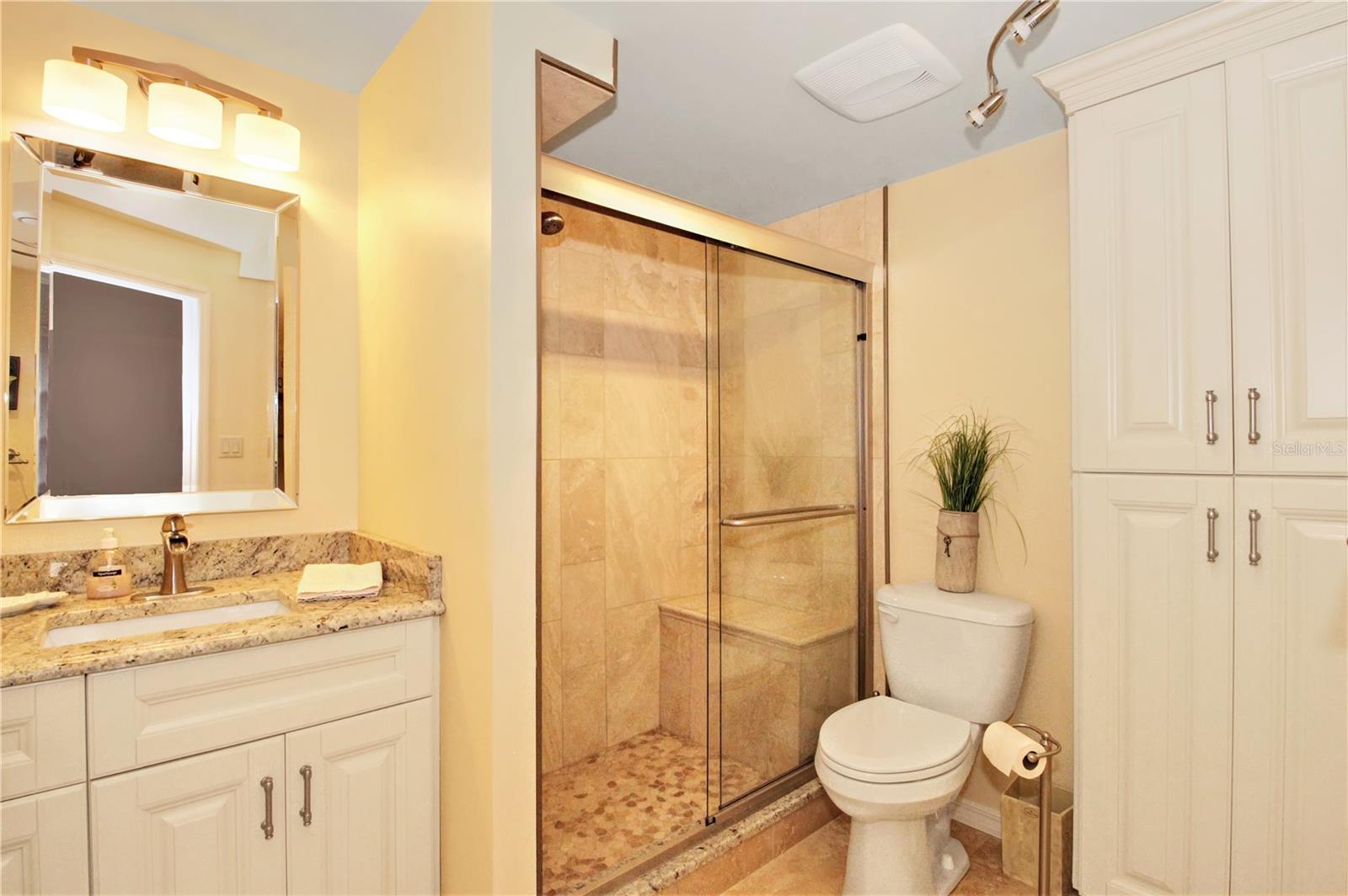 Master ensuite has oversized walk-in shower with frameless doors, granite top vanity, and custom bathroom vanity and linen closet offers plenty of bathroom storage.