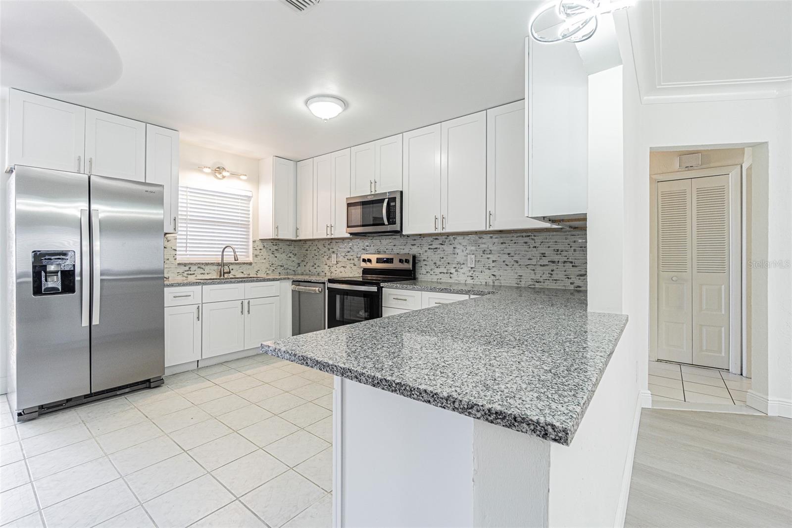 Open concept kitchen with enough cabinets for storage
