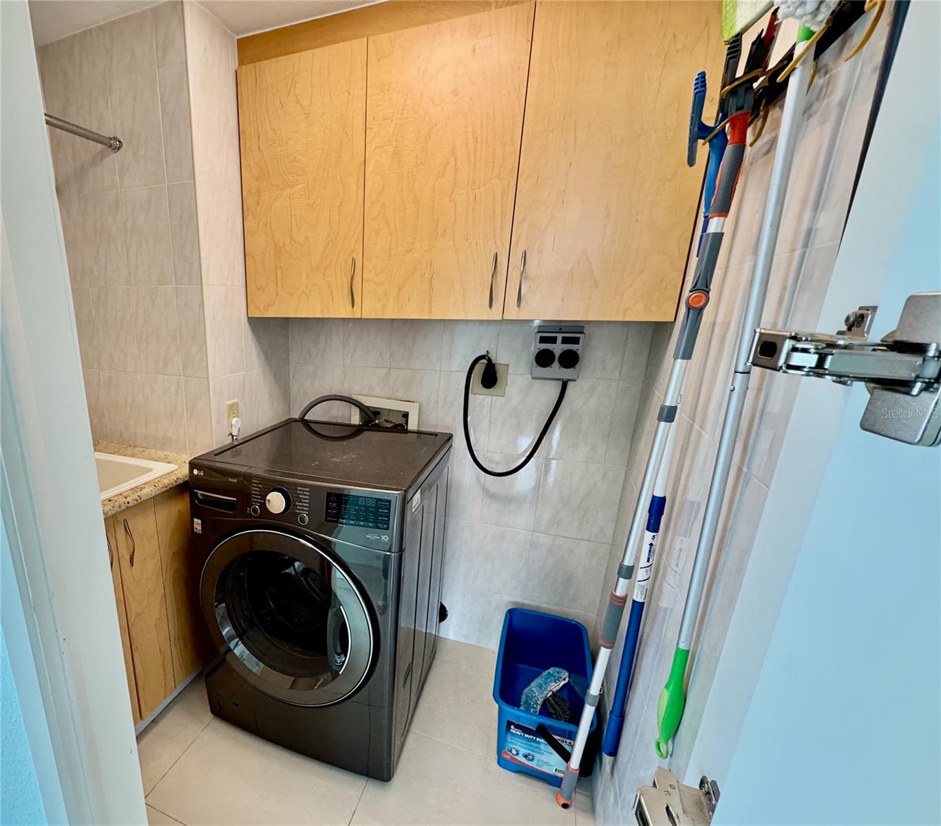 Laundry room with all in one washer dryer, sink, and storage!