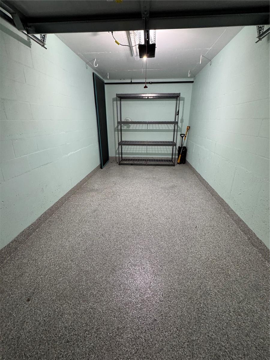 Freshly painted private garage with durable and water proof epoxy flooring and garage door opener.