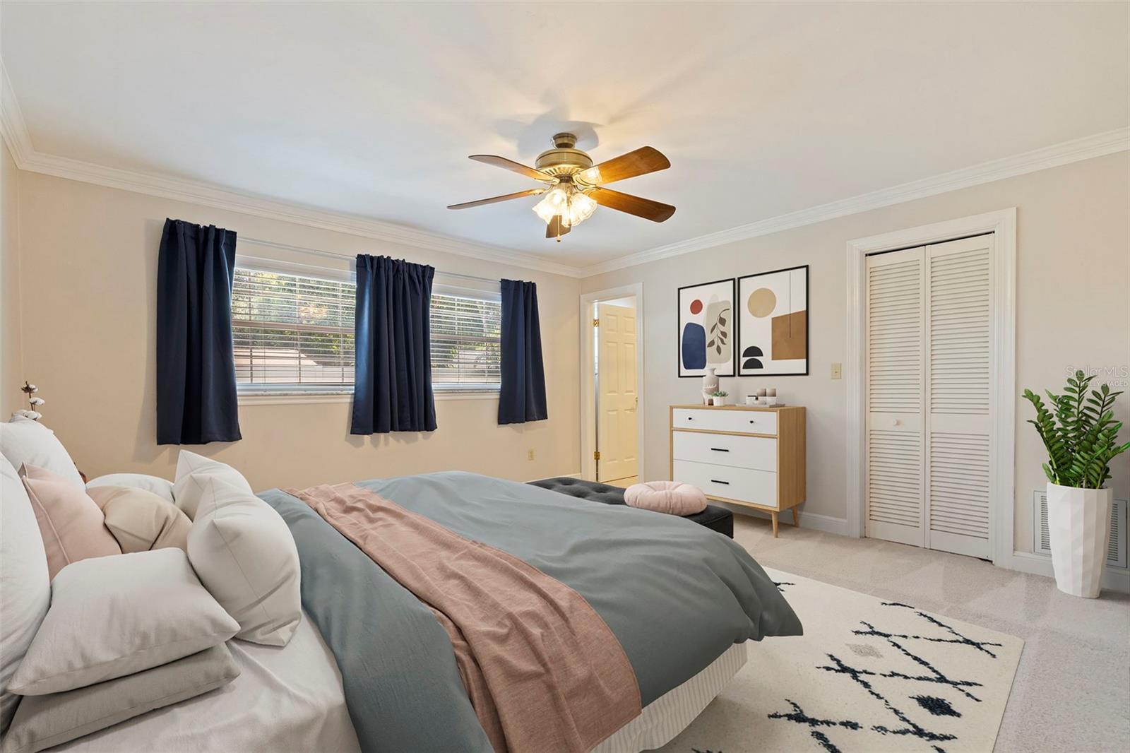 Primary bedroom with ensuite bathroom and walk-in closet *virtually staged*