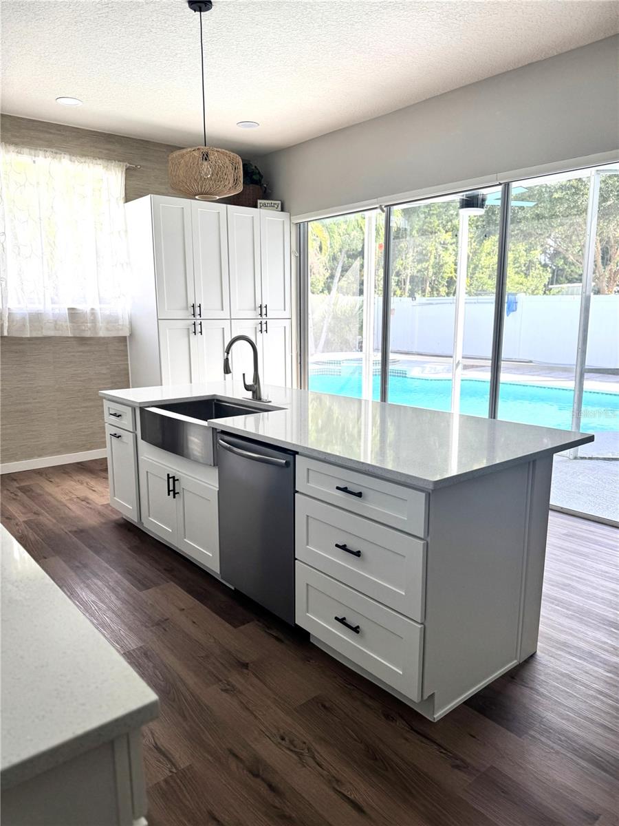 Open those sliders to the screened lanai overlooking the pool