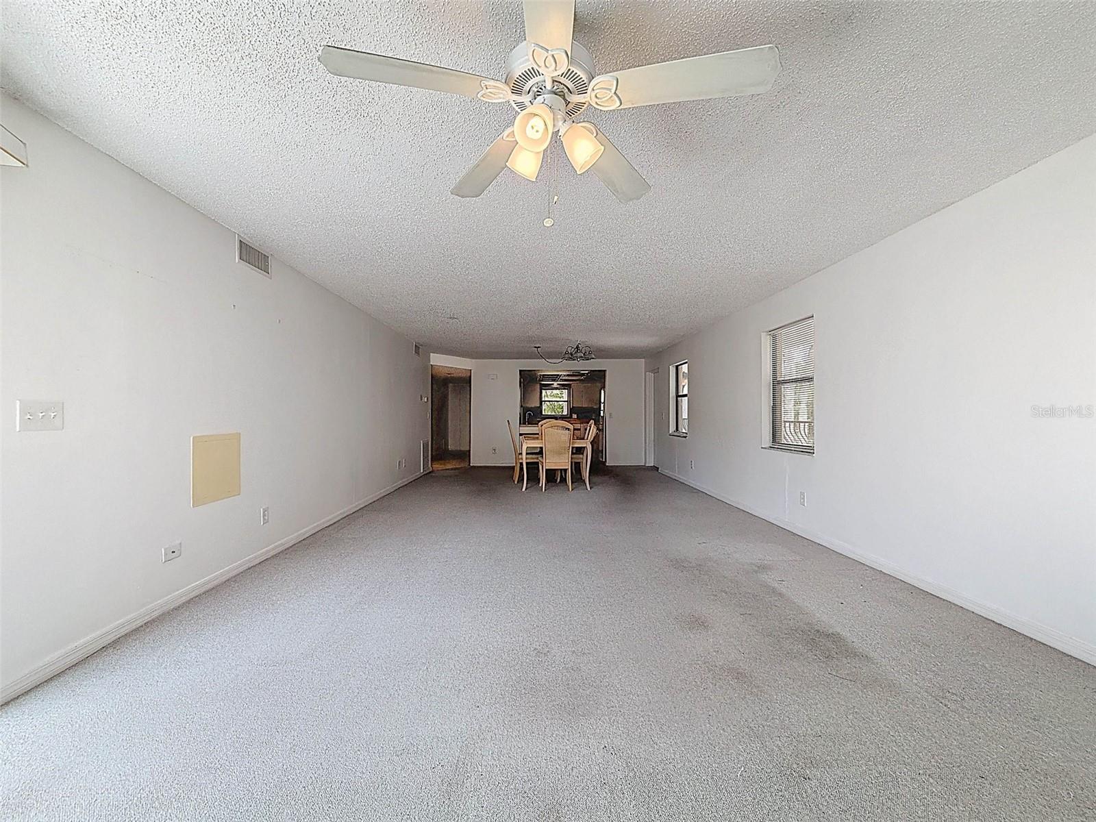 A true great room - dining room and living room leading to the screened-in patio in the back with views of the gulf.