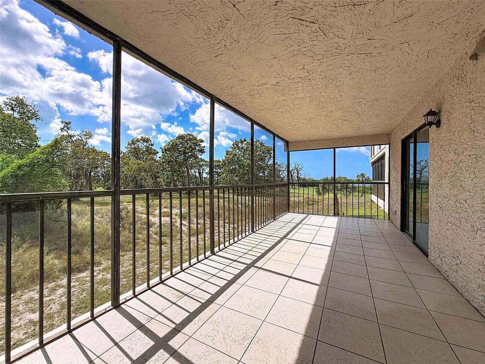 Screened-in back patio with views of the gulf. 1 of 3 private, covered patios.