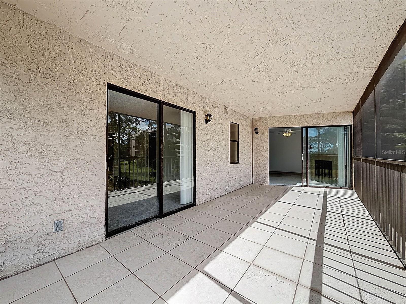 Screened-in back patio with views of the gulf. The master bedroom is to the left.