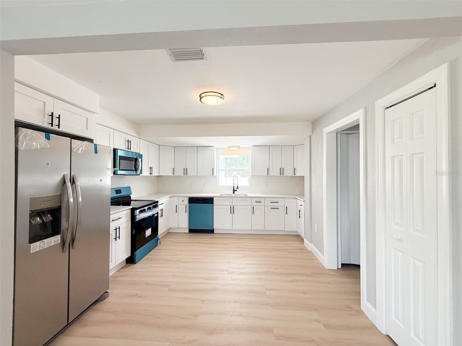 Large Kitchen with new SS appliances and quartz countertops.
