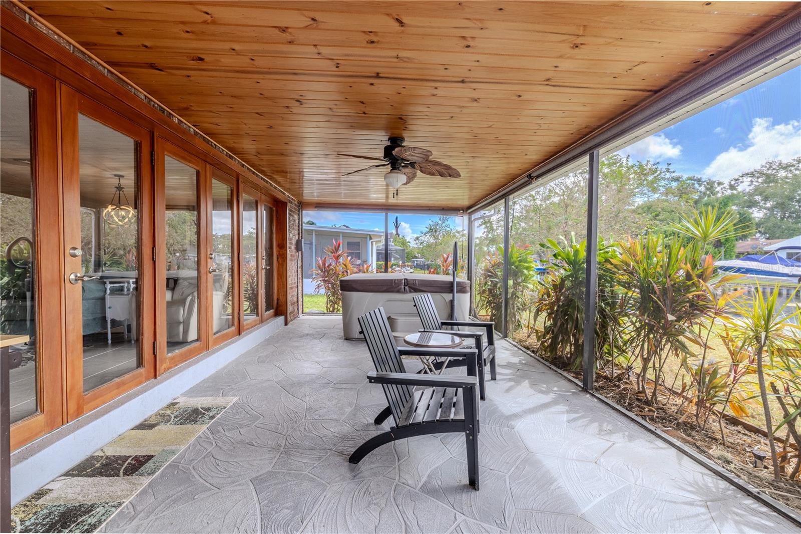 Extended screened patio offering water views and easy access to the backyard deck.