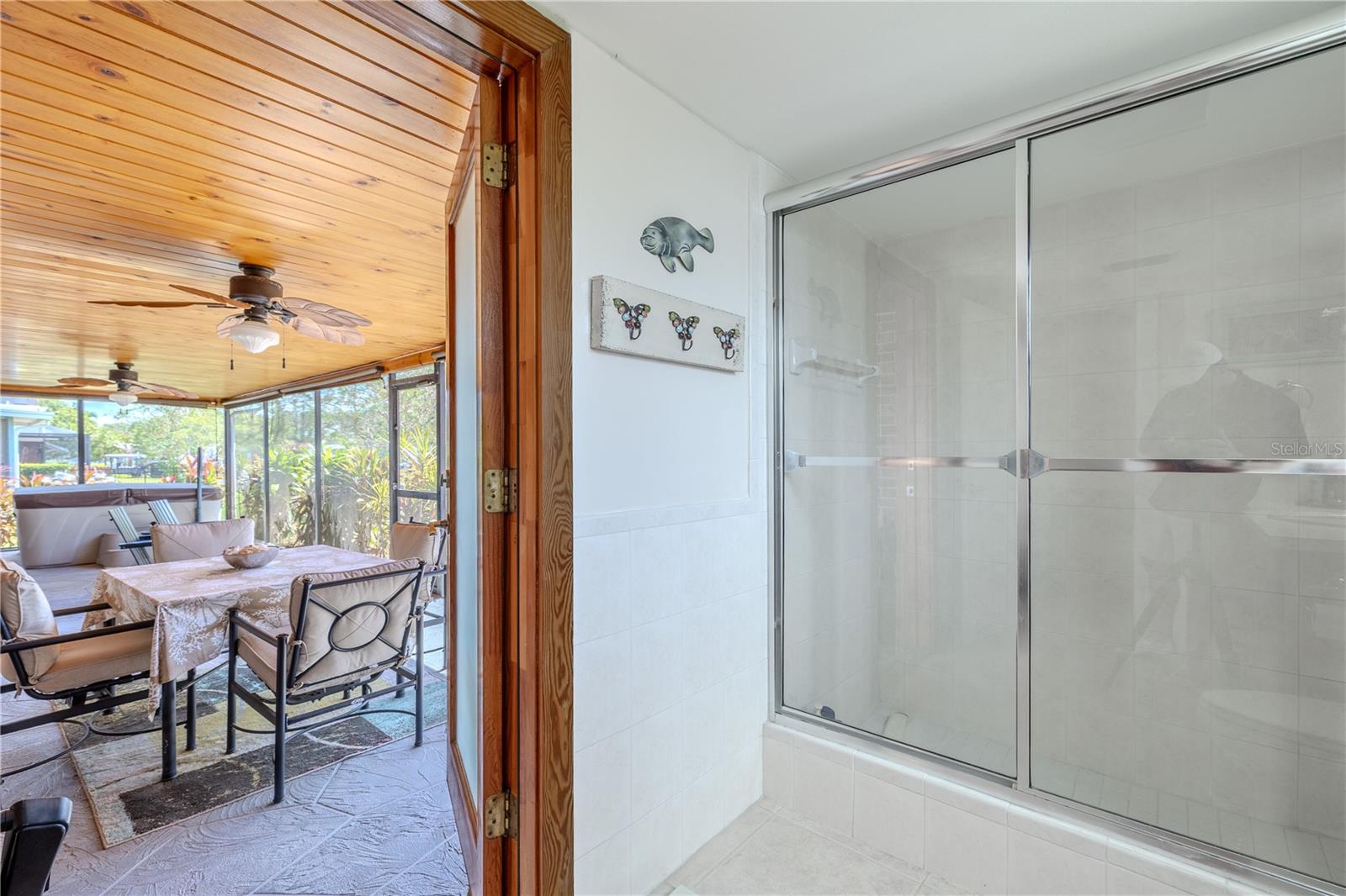 Primary bath opens directly to the screened patio for convenient indoor-outdoor living.