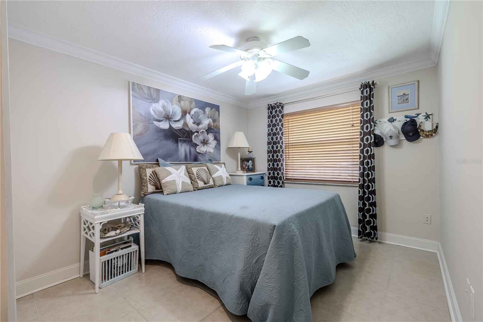 Bedroom 3 with tile flooring and natural light, ideal for guests or a home office.