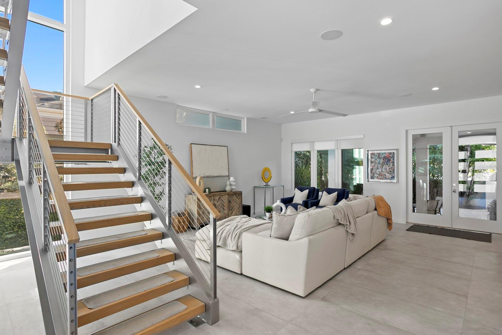 The dramatic floating staircase design sets the tone.