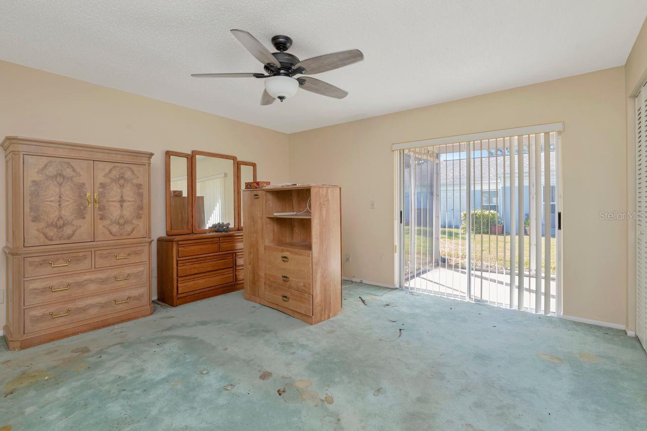 Looking into primary bedroom with patio access